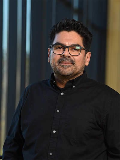 [Portrait image of Roy Vanegas. Harrison Libraries, University of Hartfort, West Hartford, CT. 24 October 2019. Photo by Jon Olson. ]